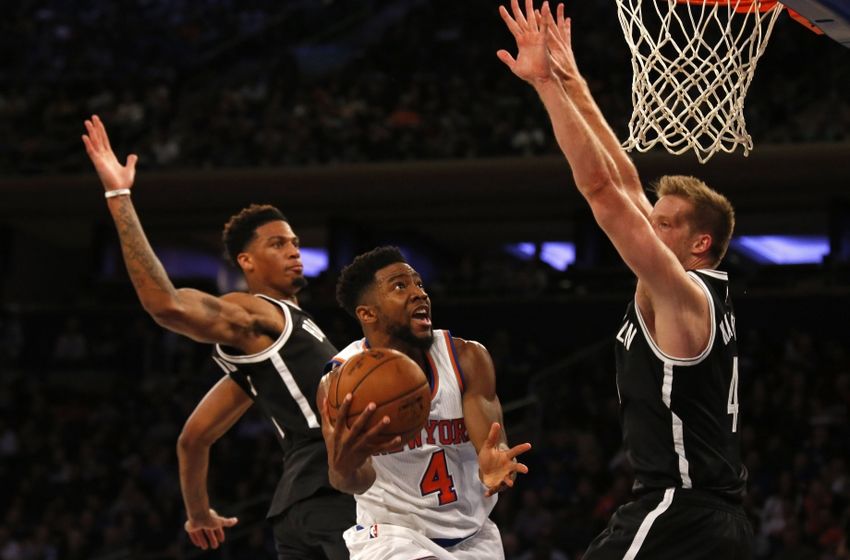 Oct 8, 2016; New York, NY, USA; New York Knicks guard Chasson Randle (4) drives to the net between Brooklyn Nets forward Chris McCullough (1) and Brooklyn Nets forward Justin Hamilton (41) during the first half at Madison Square Garden. Mandatory Credit: Adam Hunger-USA TODAY Sports