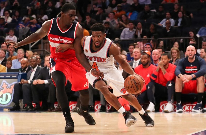Oct 10, 2016; New York, NY, USA; New York Knicks guard Chasson Randle (4) dribbles the ball past Washington Wizards forward/center Johnny O'Bryant III (7) during the fourth quarter at Madison Square Garden. The Knicks won 90-88. Mandatory Credit: Anthony Gruppuso-USA TODAY Sports