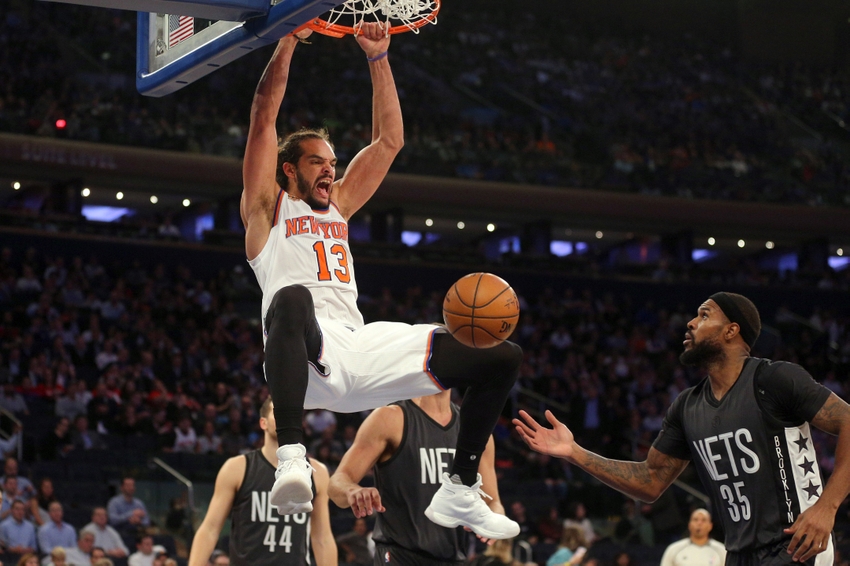 Nov 9, 2016; New York, NY, USA; New York Knicks center Joakim Noah (13) dunks over Brooklyn Nets center Brook Lopez (11) and Brooklyn Nets power forward Trevor Booker (35) during the third quarter at Madison Square Garden. Mandatory Credit: Brad Penner-USA TODAY Sports