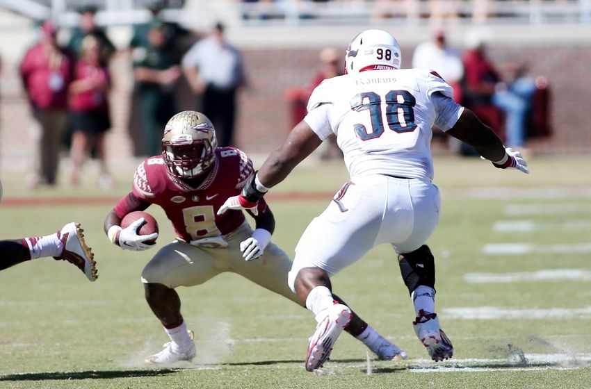 Oct 17, 2015; Tallahassee, FL, USA; Florida State player Kermit Whitfield (8) tries to escape Louisville defender Sheldon Rankins (98) as the Florida State Seminoles beat the Louisville Cardinals 41-21 at Doak Campbell Stadium. Mandatory Credit: Glenn Beil-USA TODAY Sports