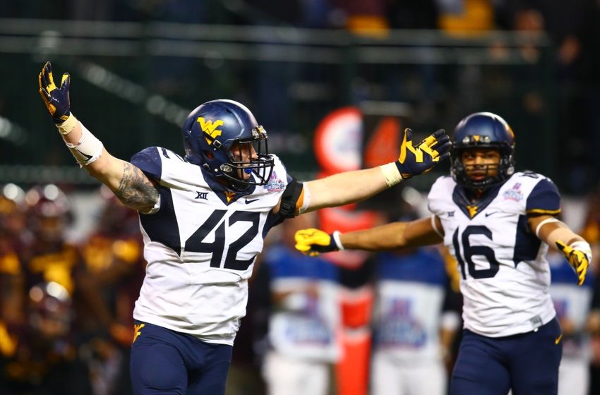 Jan 2, 2016; Phoenix, AZ, USA; West Virginia Mountaineers linebacker Jared Barber (42) and cornerback Terrell Chestnut (16) celebrate after defeating the Arizona State Sun Devils in the Cactus Bowl at Chase Field. Mandatory Credit: Mark J. Rebilas-USA TODAY Sports