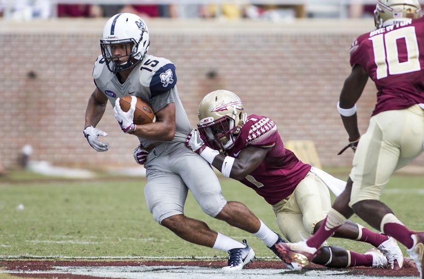 Sep 10, 2016; Tallahassee, FL, USA; Charleston Southern Buccaneers wide receiver Jared Scotland (15) is brought down by Florida State Seminoles defensive back Levonta Taylor (1) during the second half at Doak Campbell Stadium. The Florida State Seminoles defeat the Charleston Southern Buccaneers 52-8. Mandatory Credit: Glenn Beil-USA TODAY Sports