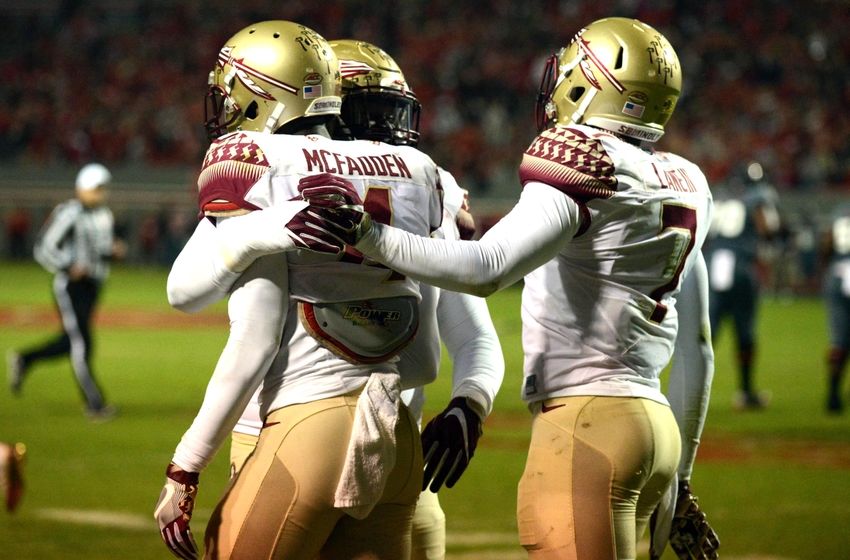 Nov 5, 2016; Raleigh, NC, USA; Florida State Seminoles defensive back Tarvarus McFadden (4) is congratulated by teammates after an interception during the first half against the North Carolina State Wolfpack at Carter Finley Stadium. Mandatory Credit: Rob Kinnan-USA TODAY Sports