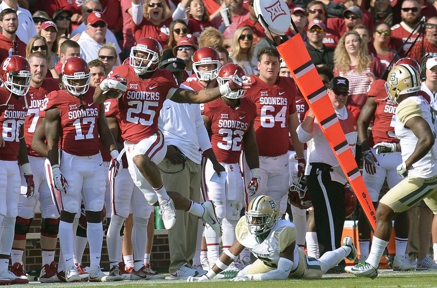 Nov 12, 2016; Norman, OK, USA; Oklahoma Sooners running back Joe Mixon (25) eludes a tackle attempt by Baylor Bears linebacker Thomas Cletcher (5) during the third quarter at Gaylord Family - Oklahoma Memorial Stadium. Mandatory Credit: Mark D. Smith-USA TODAY Sports