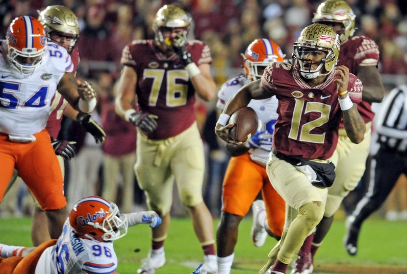 Nov 26, 2016; Tallahassee, FL, USA; Florida State Seminoles quarterback Deondre Francois (12) runs the ball past Florida Gators defensive lineman Cece Jefferson (96) during the first quarter at Doak Campbell Stadium. Mandatory Credit: Melina Vastola-USA TODAY Sports