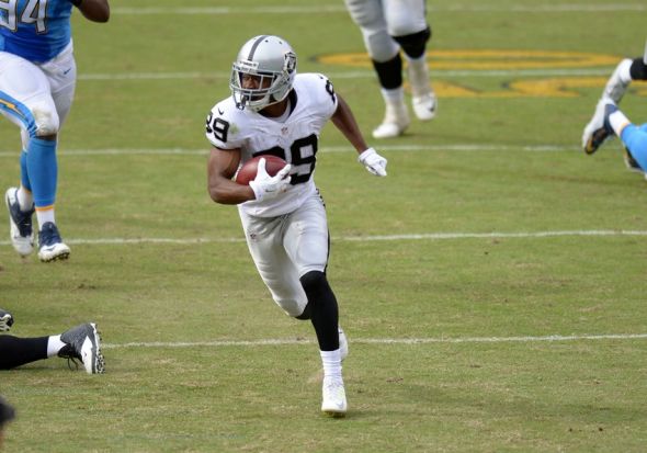 Oct 25, 2015; San Diego, CA, USA; (Editors note: Caption correction) Oakland Raider wide receiver Amari Cooper (89) runs for a touchdown after making a second quarter catch as San Diego Chargers defensive end Corey Liuget (94) gives chase at Qualcomm Stadium. Mandatory Credit: Jake Roth-USA TODAY Sports