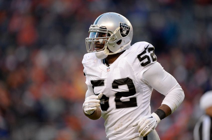 Dec 28, 2014; Denver, CO, USA; Oakland Raiders outside linebacker Khalil Mack (52) leaves the field against the Denver Broncos in the third quarter at Sports Authority Field at Mile High. The Broncos defeated the Raiders 47-14. Mandatory Credit: Ron Chenoy-USA TODAY Sports