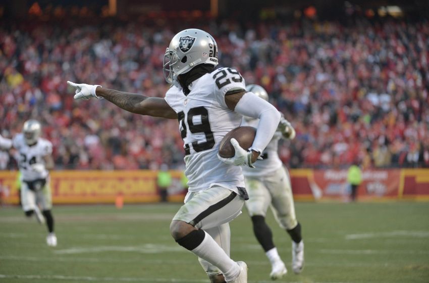 Jan 3, 2016; Kansas City, MO, USA; Oakland Raiders cornerback David Amerson (29) intercepts a pass and runs in for a touchdown during the first half against the Kansas City Chiefs at Arrowhead Stadium. Mandatory Credit: Denny Medley-USA TODAY Sports