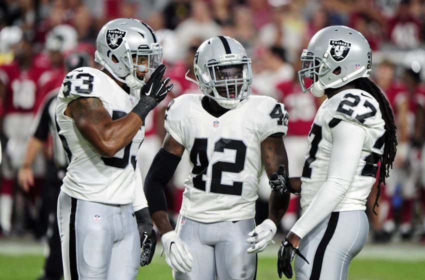 Aug 12, 2016; Glendale, AZ, USA; Oakland Raiders safety Karl Joseph (42) talks with defensive back Reggie Nelson (27) and outside linebacker Malcolm Smith (53) during the first half at University of Phoenix Stadium. Mandatory Credit: Matt Kartozian-USA TODAY Sports