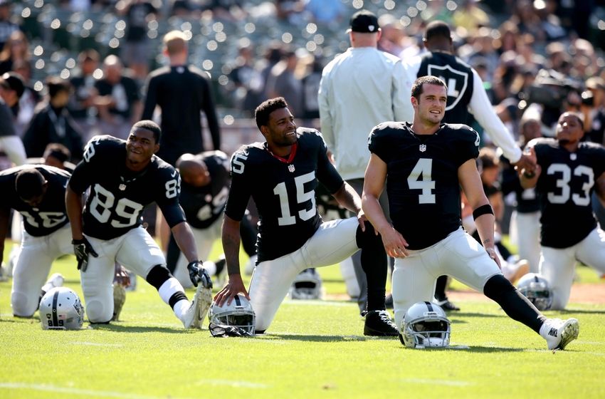Aug 27, 2016; Oakland, CA, USA; Oakland Raiders quarterback Derek Carr (4), wide receiver Michael Crabtree (15) and wide receiver Amari Cooper (89) warm up before the start of the game against the Tennessee Titans at Oakland Alameda Coliseum. Mandatory Credit: Cary Edmondson-USA TODAY Sports