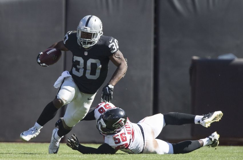 September 18, 2016; Oakland, CA, USA; Oakland Raiders running back Jalen Richard (30) runs with the football past Atlanta Falcons linebacker Sean Weatherspoon (56) during the third quarter at Oakland Coliseum. The Falcons defeated the Raiders 35-28. Mandatory Credit: Kyle Terada-USA TODAY Sports