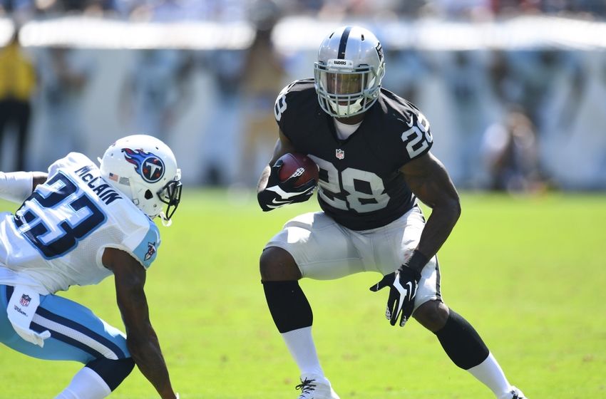 Sep 25, 2016; Nashville, TN, USA; Oakland Raiders running back Latavius Murray (28) carries the ball as Tennessee Titans cornerback Brice McCain (23) defends during the first half at Nissan Stadium. Mandatory Credit: Christopher Hanewinckel-USA TODAY Sports