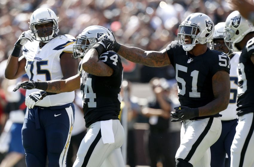 Oct 9, 2016; Oakland, CA, USA; Oakland Raiders linebacker Perry Riley Jr. (54) is congratulated by outside linebacker Bruce Irvin (51) after forcing a fumble against the San Diego Chargers in the first quarter at Oakland Coliseum. Mandatory Credit: Cary Edmondson-USA TODAY Sports