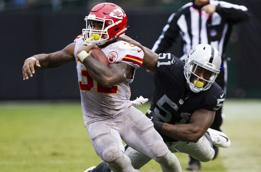 Oct 16, 2016; Oakland, CA, USA; Kansas City Chiefs running back Spencer Ware (32) escapes Oakland Raiders outside linebacker Bruce Irvin (51) during the third quarter at Oakland Coliseum. The Kansas City Chiefs defeated the Oakland Raiders 26-10. Mandatory Credit: Kelley L Cox-USA TODAY Sports