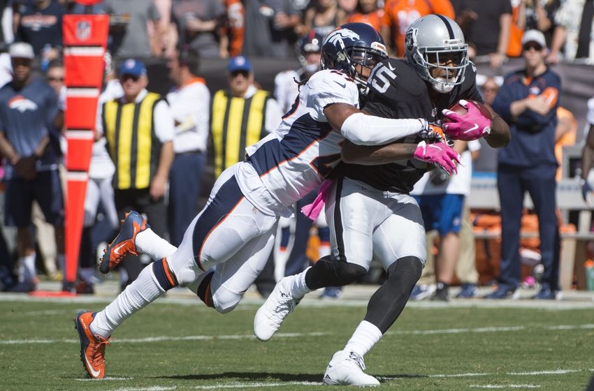 October 11, 2015; Oakland, CA, USA; Oakland Raiders wide receiver Michael Crabtree (15) is tackled by Denver Broncos cornerback Bradley Roby (29) during the first quarter at O.co Coliseum. Mandatory Credit: Kyle Terada-USA TODAY Sports