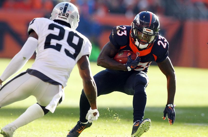 Dec 13, 2015; Denver, CO, USA; Denver Broncos running back Ronnie Hillman (23) runs the ball against Oakland Raiders cornerback David Amerson (29) during the first half at Sports Authority Field at Mile High. Mandatory Credit: Chris Humphreys-USA TODAY Sports