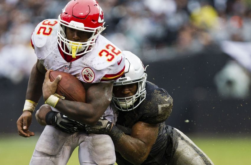 Oct 16, 2016; Oakland, CA, USA; Kansas City Chiefs running back Spencer Ware (32) is brought down by Oakland Raiders middle linebacker Cory James (57) during the third quarter at Oakland Coliseum. The Kansas City Chiefs defeated the Oakland Raiders 26-10. Mandatory Credit: Kelley L Cox-USA TODAY Sports