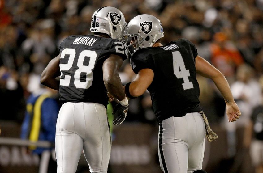 Nov 6, 2016; Oakland, CA, USA; Oakland Raiders quarterback Derek Carr (4) congratulates running back Latavius Murray (28) after Murray rushed for a touchdown against the Denver Broncos in the second quarter at Oakland Coliseum. Mandatory Credit: Cary Edmondson-USA TODAY Sports