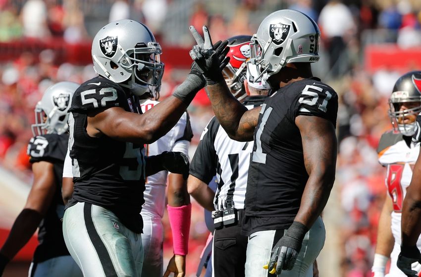 Oct 30, 2016; Tampa, FL, USA; Oakland Raiders defensive end Khalil Mack (52) and outside linebacker Bruce Irvin (51) congratulate each other against the Tampa Bay Buccaneers during the second half at Raymond James Stadium. Oakland Raiders defeated the Tampa Bay Buccaneers 30-24 in overtime. Mandatory Credit: Kim Klement-USA TODAY Sports