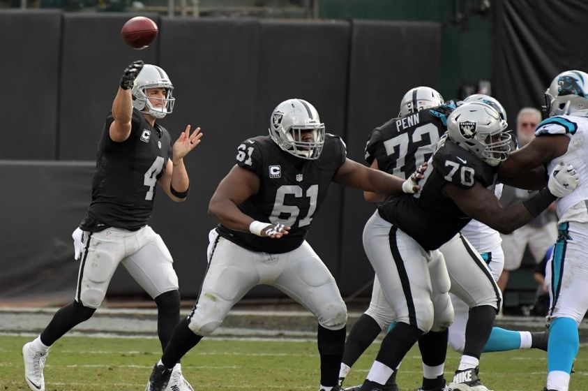 Nov 27, 2016; Oakland, CA, USA; Oakland Raiders quarterback Derek Carr (4) throws as center Rodney Hudson (61) and offensive guard Kelechi Osemele (70) block against the Carolina Panthers during the second half at Oakland-Alameda County Coliseum. Mandatory Credit: Kirby Lee-USA TODAY Sports