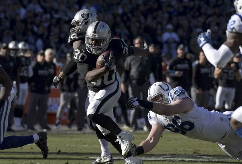Dec 24, 2016; Oakland, CA, USA; Oakland Raiders running back Jalen Richard (30) is defended by Indianapolis Colts defensive end Henry Anderson (96) during a NFL football game at Oakland-Alameda County Coliseum. The Raiders defeated the Colts 33-25. Mandatory Credit: Kirby Lee-USA TODAY Sports