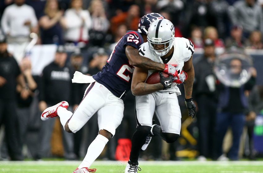Jan 7, 2017; Houston, TX, USA; Oakland Raiders wide receiver Michael Crabtree (15) is tackled by Houston Texans cornerback Johnathan Joseph (24) during the second quarter of the AFC Wild Card playoff football game at NRG Stadium. Mandatory Credit: Troy Taormina-USA TODAY Sports