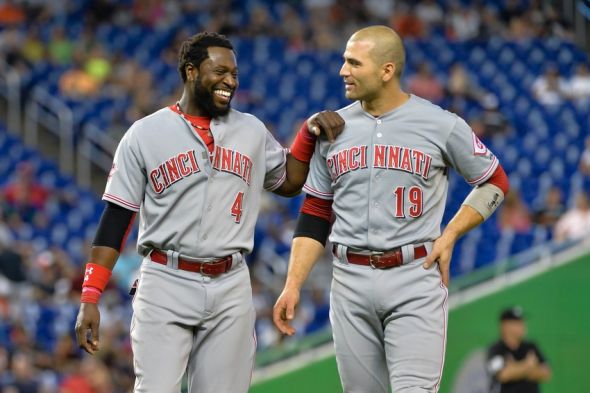 Jul 11, 2015; Miami, FL, USA; Cincinnati Reds second baseman Brandon Phillips (left) talks with first baseman Joey Votto (right) during the fifth inning against the Miami Marlins at Marlins Park. Mandatory Credit: Steve Mitchell-USA TODAY Sports
