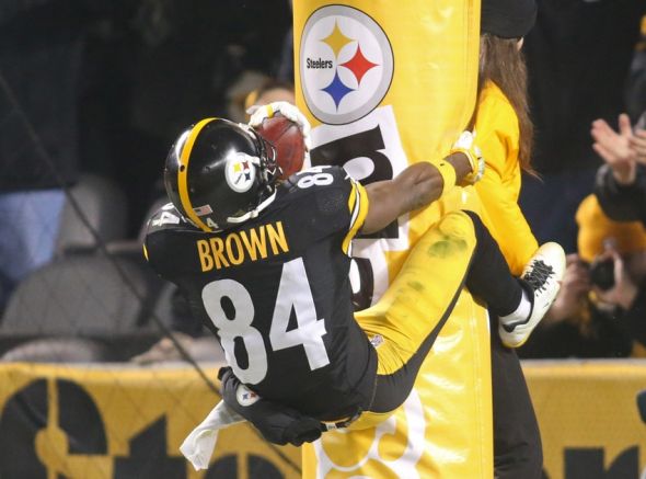 Dec 6, 2015; Pittsburgh, PA, USA; Pittsburgh Steelers wide receiver Antonio Brown (84) jumps onto the goal post padding after scoring on a seventy-one yard punt return for a touchdown against the Indianapolis Colts during the fourth quarter at Heinz Field. The Steelers won 45-10. Mandatory Credit: Charles LeClaire-USA TODAY Sports