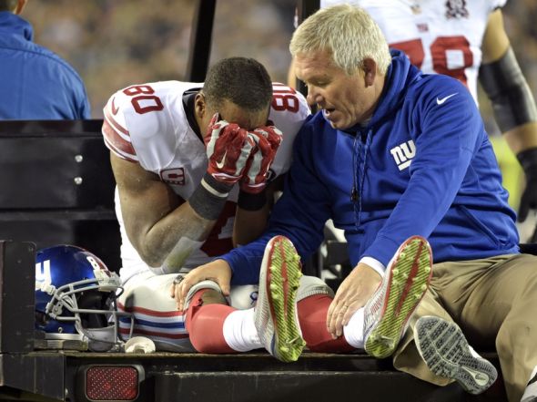 Oct 12, 2014; Philadelphia, PA, USA; New York Giants wide receiver Victor Cruz (80) with trainer Byron Hansen as he is carted off the field after an injury during the third quarter against the Philadelphia Eagles at Lincoln Financial Field. Mandatory Credit: Eric Hartline-USA TODAY Sports
