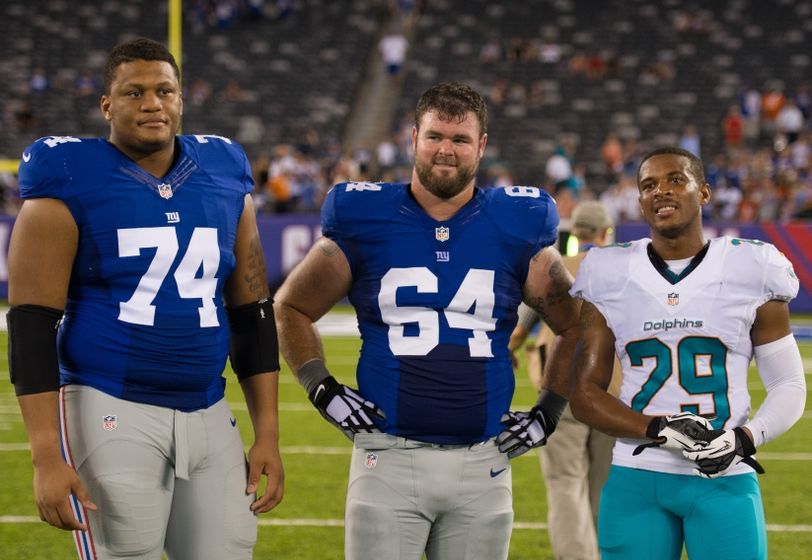 Aug 12, 2016; East Rutherford, NJ, USA; Miami Dolphins defensive back Chris Culliver (29) New York Giants center Shane McDermott (64) and New York Giants offensive tackle Ereck Flowers (74) after the game at MetLife Stadium. The Miami Dolphins defeat the New York Giants 27-10. Mandatory Credit: William Hauser-USA TODAY Sports
