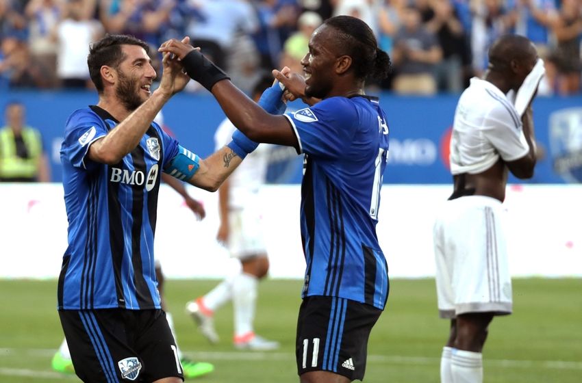 Jun 25, 2016; Montreal, Quebec, CAN; Montreal Impact midfielder Ignacio Piatti (10) celebrates with teammate forward Didier Drogba (11) after scoring a goal against Sporting Kansas City during the first half at Stade Saputo. Mandatory Credit: Jean-Yves Ahern-USA TODAY Sports