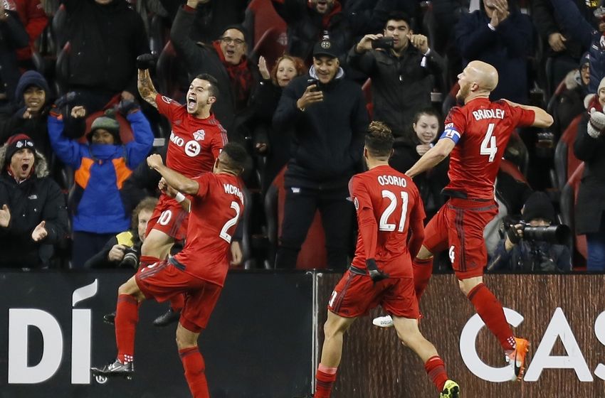 Oct 26, 2016; Toronto, CANADA; Toronto FC defender Justin Morrow (2) and midfielder Jonathan Osorio (21) and midfielder Michael Bradley (4) celebrate a goal by forward Sebastian Giovinco (left) during the first half against the Philadelphia Union at BMO Field. Mandatory Credit: John E. Sokolowski-USA TODAY Sports