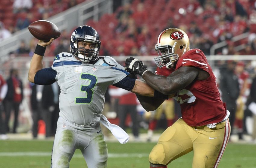 November 27, 2014; Santa Clara, CA, USA; Seattle Seahawks quarterback Russell Wilson (3) passes the football against San Francisco 49ers defensive end Tank Carradine (95) during the fourth quarter at Levi's Stadium. The Seahawks defeated the 49ers 19-3. Mandatory Credit: Kyle Terada-USA TODAY Sports