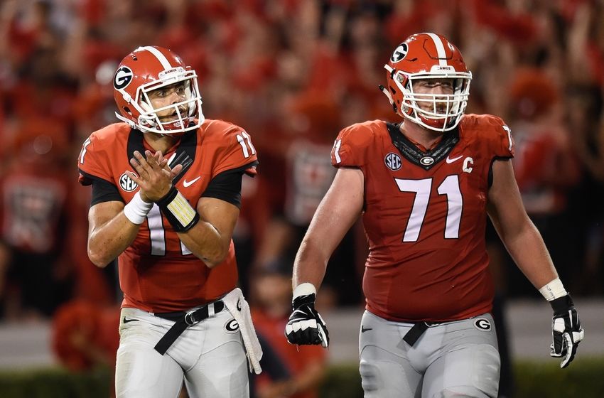 Sep 19, 2015; Athens, GA, USA; Georgia Bulldogs quarterback Greyson Lambert (11) reacts with offensive tackle John Theus (71) after a Georgia touchdown against the South Carolina Gamecocks during the second half at Sanford Stadium. Georgia defeated South Carolina 52-20. Mandatory Credit: Dale Zanine-USA TODAY Sports