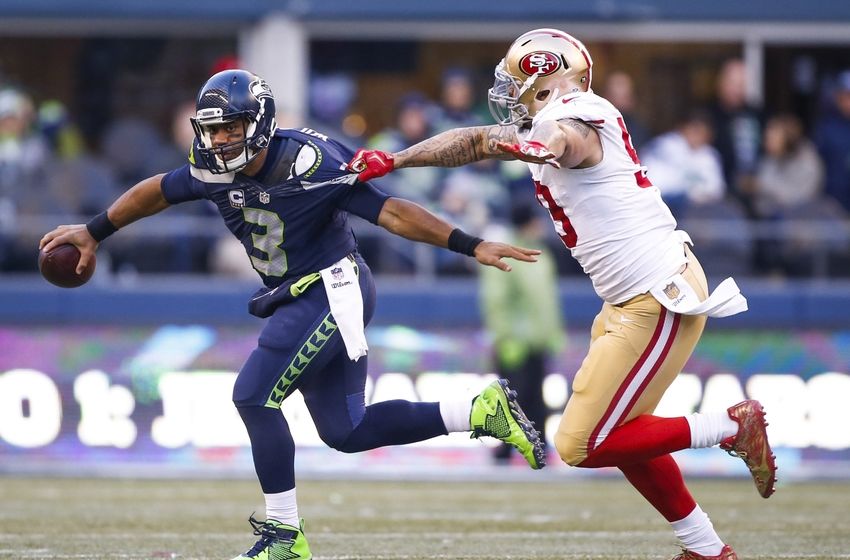 Nov 22, 2015; Seattle, WA, USA; Seattle Seahawks quarterback Russell Wilson (3) eludes a sack against the San Francisco 49ers during the fourth quarter at CenturyLink Field. Seattle defeated San Francisco, 29-13. Mandatory Credit: Joe Nicholson-USA TODAY Sports