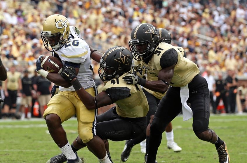 Sep 17, 2016; Atlanta, GA, USA; Georgia Tech Yellow Jackets running back Dedrick Mills (26) scores a rushing touchdown against Vanderbilt Commodores linebacker Zach Cunningham (41) and cornerback Tre Herndon (31) in the third quarter of their game at Bobby Dodd Stadium. The Yellow Jackets won 38-7. Mandatory Credit: Jason Getz-USA TODAY Sports