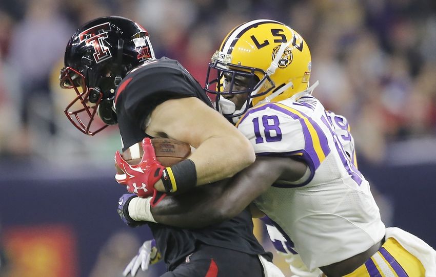Dec 29, 2015; Houston, TX, USA; Texas Tech Red Raiders wide receiver Ian Sadler (12) is tackled by LSU Tigers cornerback Tre'Davious White (18) in the first quarter at NRG Stadium. Mandatory Credit: Thomas B. Shea-USA TODAY Sports