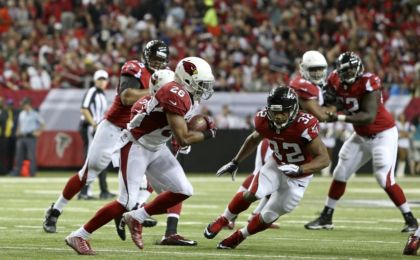 Nov 30, 2014; Atlanta, GA, USA; Arizona Cardinals free safety Rashad Johnson (26) returns an interception for a touchdown as he runs past Atlanta Falcons running back Jacquizz Rodgers (32) in the second quarter of their game at the at the Georgia Dome. Mandatory Credit: Jason Getz-USA TODAY Sports