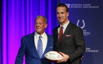Mar 18, 2016; Indianapolis, IN, USA; Indianapolis Colts owner Jim Irsay presents Peyton Manning with a football during a press conference at Indiana Farm Bureau Football Center. Mandatory Credit: Brian Spurlock-USA TODAY Sports