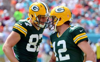 Oct 12, 2014; Miami Gardens, FL, USA; Green Bay Packers quarterback Aaron Rodgers (right) celebrates with wide receiver Jordy Nelson (left) after throwing a touchdown pass against the Miami Dolphins during the first half at Sun Life Stadium. Mandatory Credit: Steve Mitchell-USA TODAY Sports
