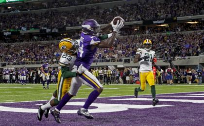 Minnesota Vikings wide receiver Stefon Diggs (14) catches a touchdown pass past Green Bay Packers cornerback <a rel=