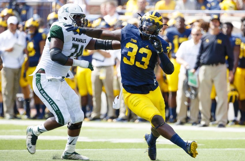 Michigan Wolverines defensive end Taco Charlton (33) rushes on Hawaii Warriors offensive lineman RJ Hollis (74) at Michigan Stadium. Rick Osentoski-USA TODAY Sports