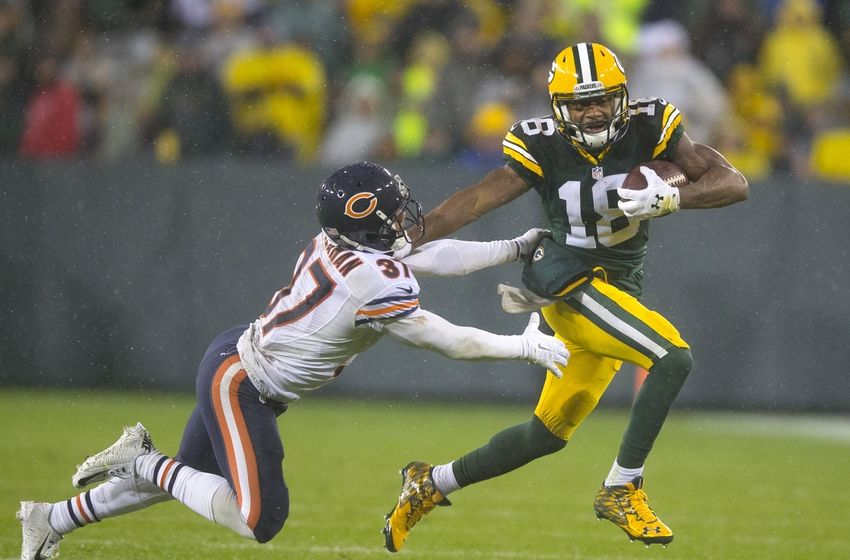Nov 26, 2015; Green Bay, WI, USA; Green Bay Packers wide receiver Randall Cobb (18) rushes with the football as Chicago Bears cornerback Bryce Callahan (37) defends during the fourth quarter of a NFL game on Thanksgiving at Lambeau Field. Mandatory Credit: Jeff Hanisch-USA TODAY Sports