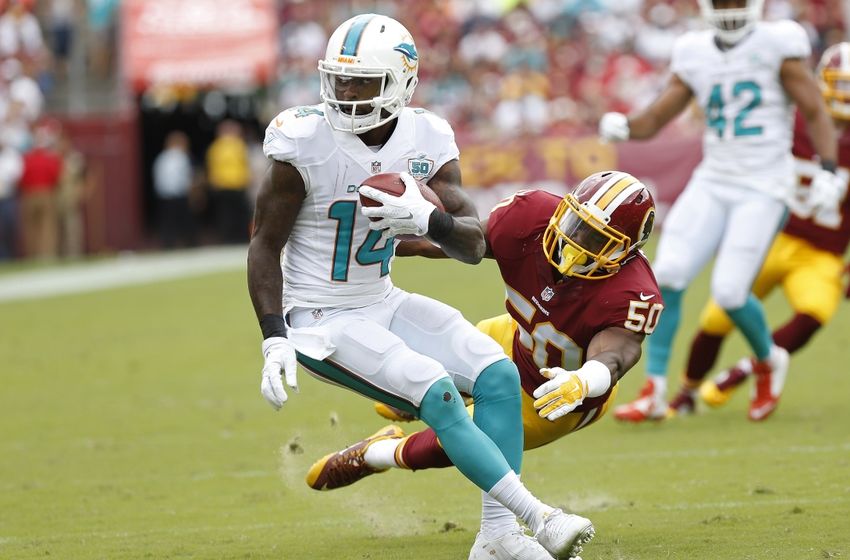 Sep 13, 2015; Landover, MD, USA; Miami Dolphins wide receiver Jarvis Landry (14) runs with the ball as Washington Redskins outside linebacker Martrell Spaight (50) attempts the tackle in the third quarter at FedEx Field. The Dolphins won 17-10. Mandatory Credit: Geoff Burke-USA TODAY Sports