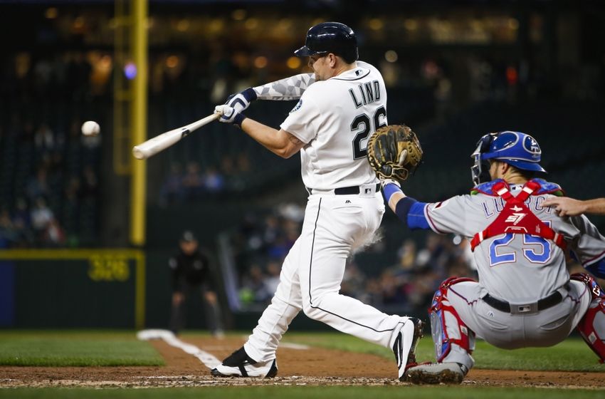Sep 7, 2016; Seattle, WA, USA; Seattle Mariners first baseman Adam Lind (26) hits a grand slam against the Texas Rangers during the first inning at Safeco Field. Mandatory Credit: Joe Nicholson-USA TODAY Sports