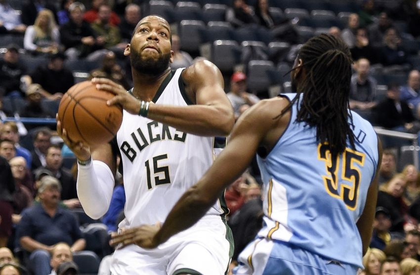 Nov 30, 2015; Milwaukee, WI, USA; Milwaukee Bucks center Greg Monroe (15) takes a shot against Denver Nuggets forward Kenneth Faried (35) at BMO Harris Bradley Center. Monroe scored 18 points as the Bucks beat the Nuggets 92-74. Mandatory Credit: Benny Sieu-USA TODAY Sports
