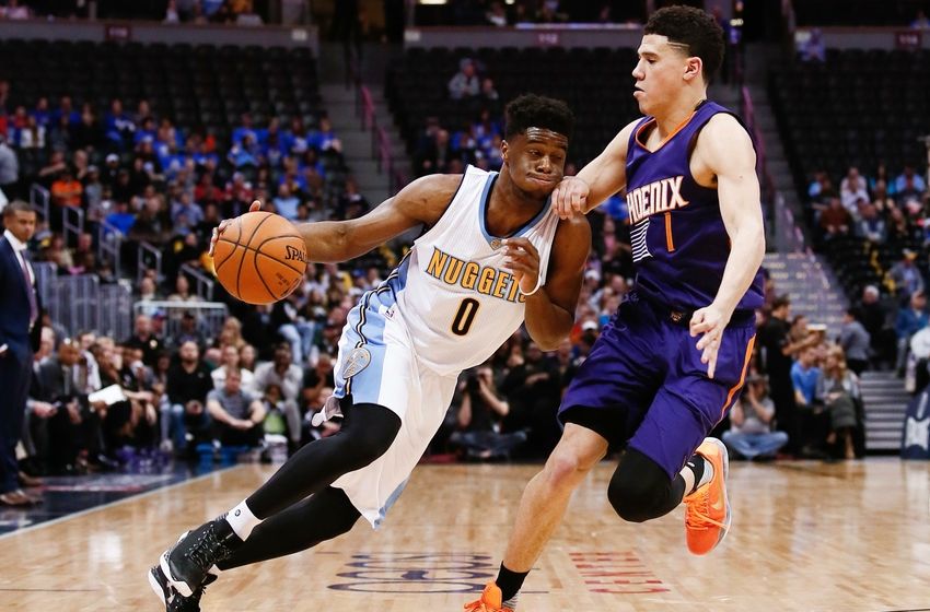 Mar 10, 2016; Denver, CO, USA; Phoenix Suns guard Devin Booker (1) guards Denver Nuggets guard Emmanuel Mudiay (0) in the second quarter at the Pepsi Center. Mandatory Credit: Isaiah J. Downing-USA TODAY Sports