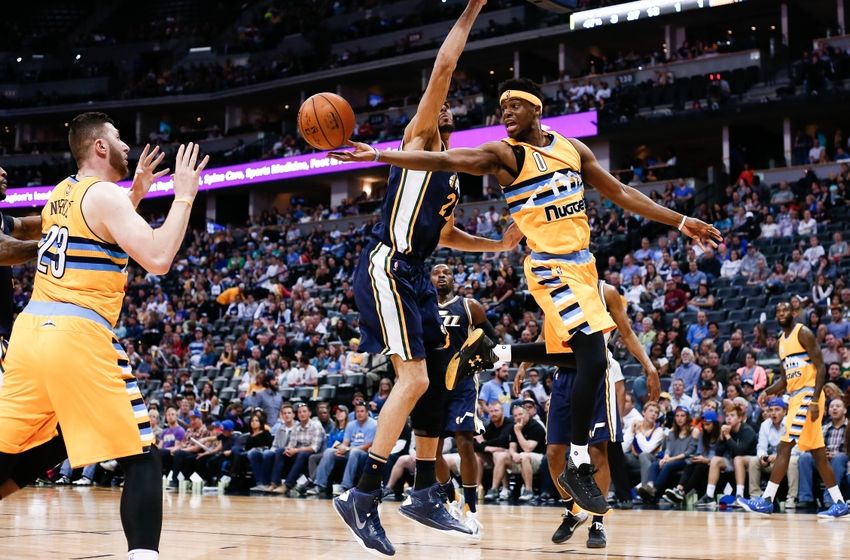 Apr 10, 2016; Denver, CO, USA; Denver Nuggets guard Emmanuel Mudiay (0) passes the ball to center Jusuf Nurkic (23) around Utah Jazz center Rudy Gobert (27) in the third quarter at the Pepsi Center. The Jazz defeated the Nuggets 100-84. Mandatory Credit: Isaiah J. Downing-USA TODAY Sports