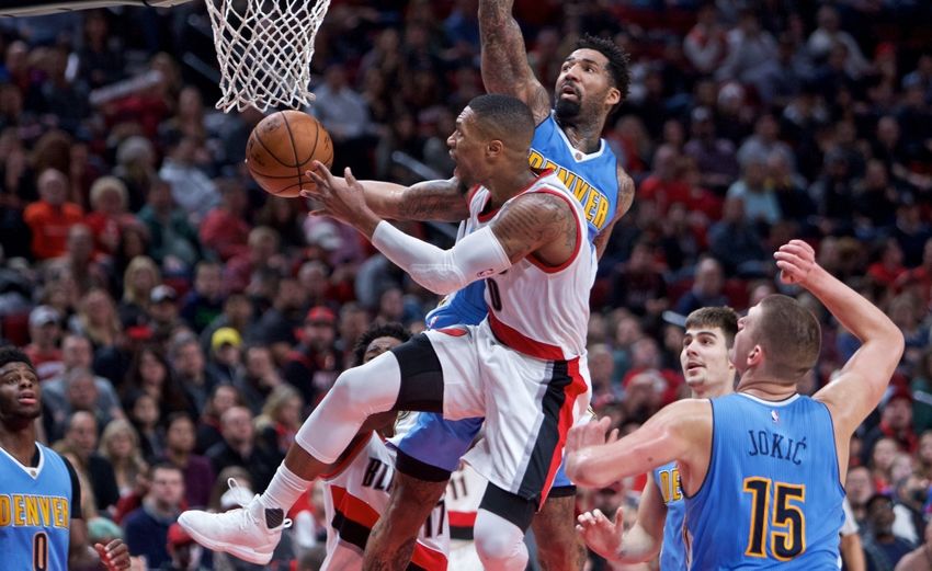 Nov 13, 2016; Portland, OR, USA; Portland Trail Blazers guard Damian Lillard (0) shoots over Denver Nuggets forward Wilson Chandler (21) during the fourth quarter at the Moda Center. Mandatory Credit: Craig Mitchelldyer-USA TODAY Sports