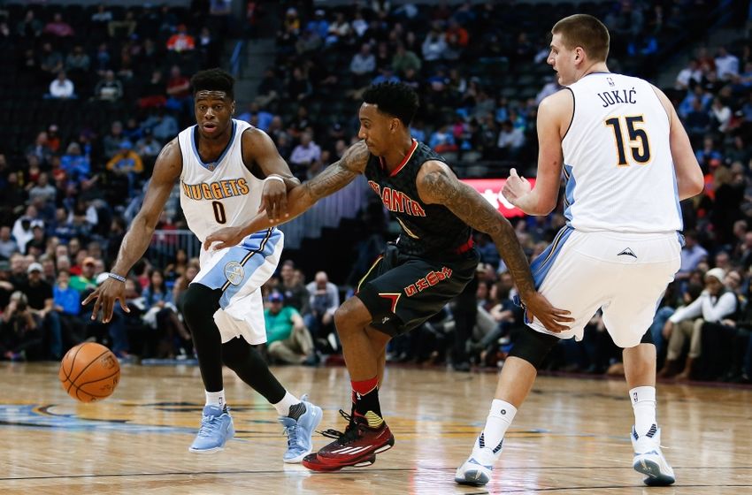 Jan 25, 2016; Denver, CO, USA; Denver Nuggets center Nikola Jokic (15) defends as guard Emmanuel Mudiay (0) dribbles the ball against Atlanta Hawks guard Jeff Teague (0) in the third quarter at the Pepsi Center. The Hawks defeated the Nuggets 119-105. Mandatory Credit: Isaiah J. Downing-USA TODAY Sports